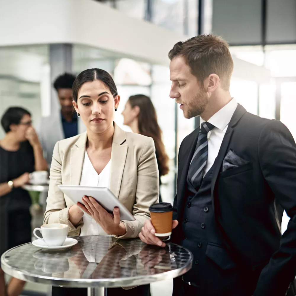 a man and women talking while drinking coffee