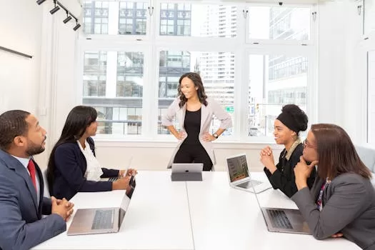 Woman speaking in front of board members