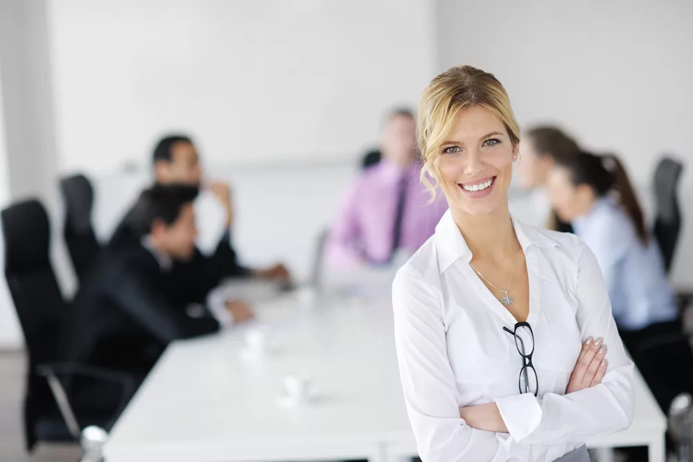 Executive woman smiling at a board meeting